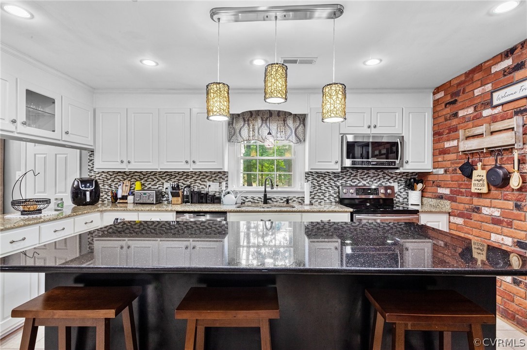 3905 Cresthill Road Chester, VA 23831 - Photo 13 of 49 a kitchen with granite countertop a sink stainless steel appliances and cabinets