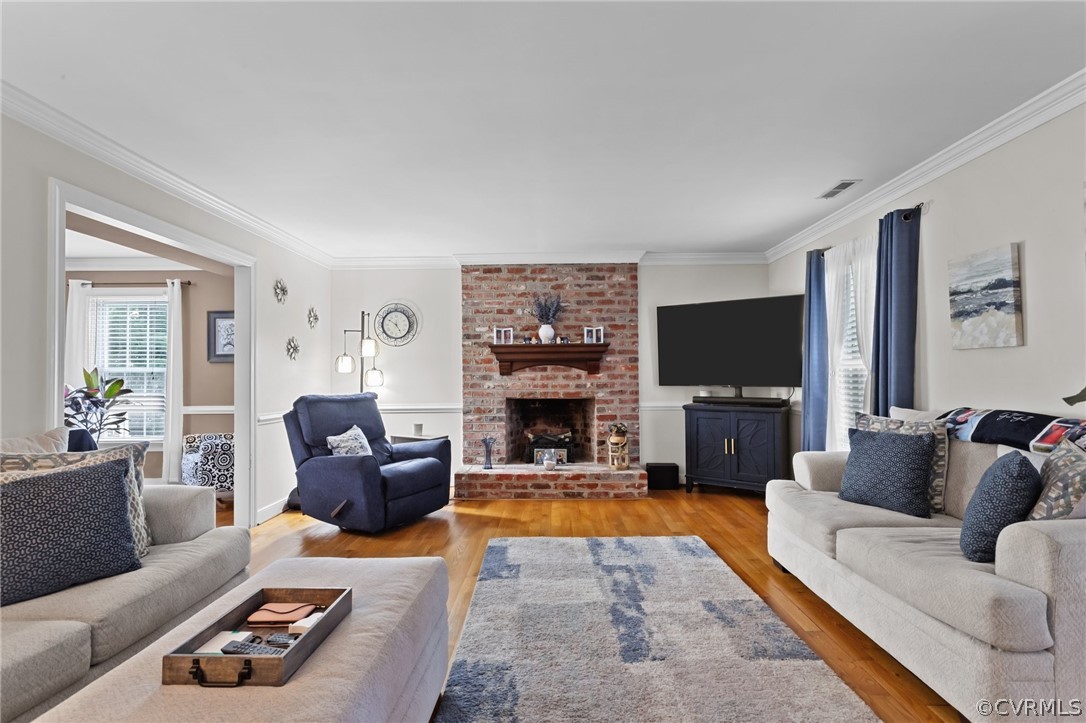 3905 Cresthill Road Chester, VA 23831 - Photo 19 of 49 a living room with furniture a flat screen tv and a fireplace
