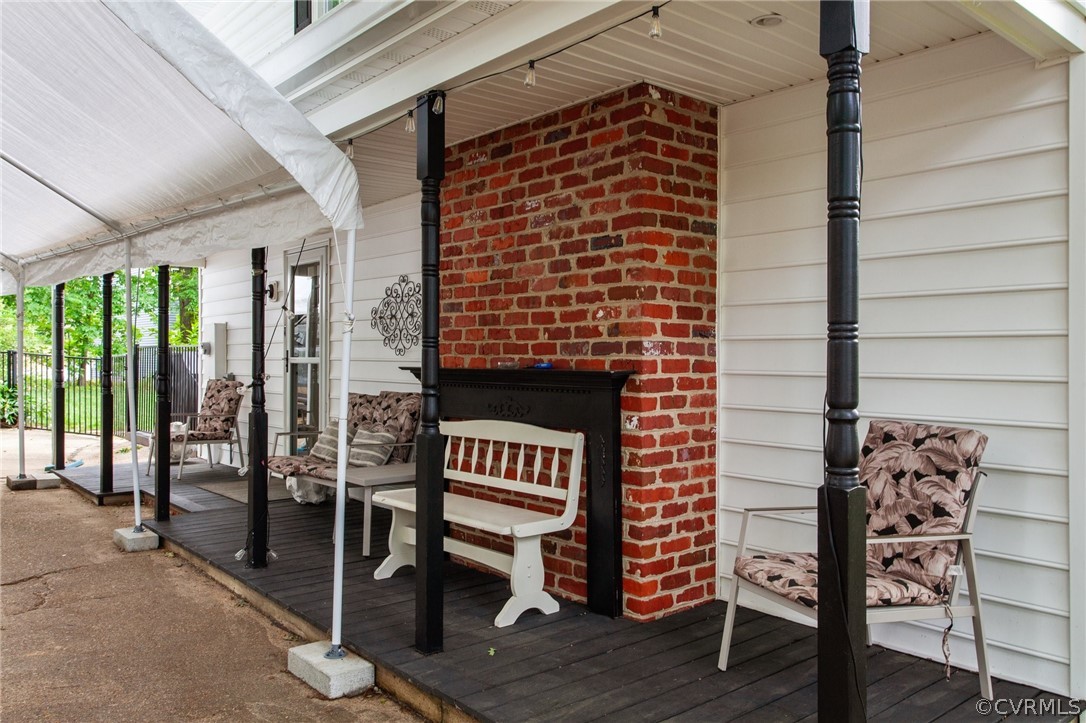 3905 Cresthill Road Chester, VA 23831 - Photo 45 of 49 a view of a patio with table and chairs and wooden floor