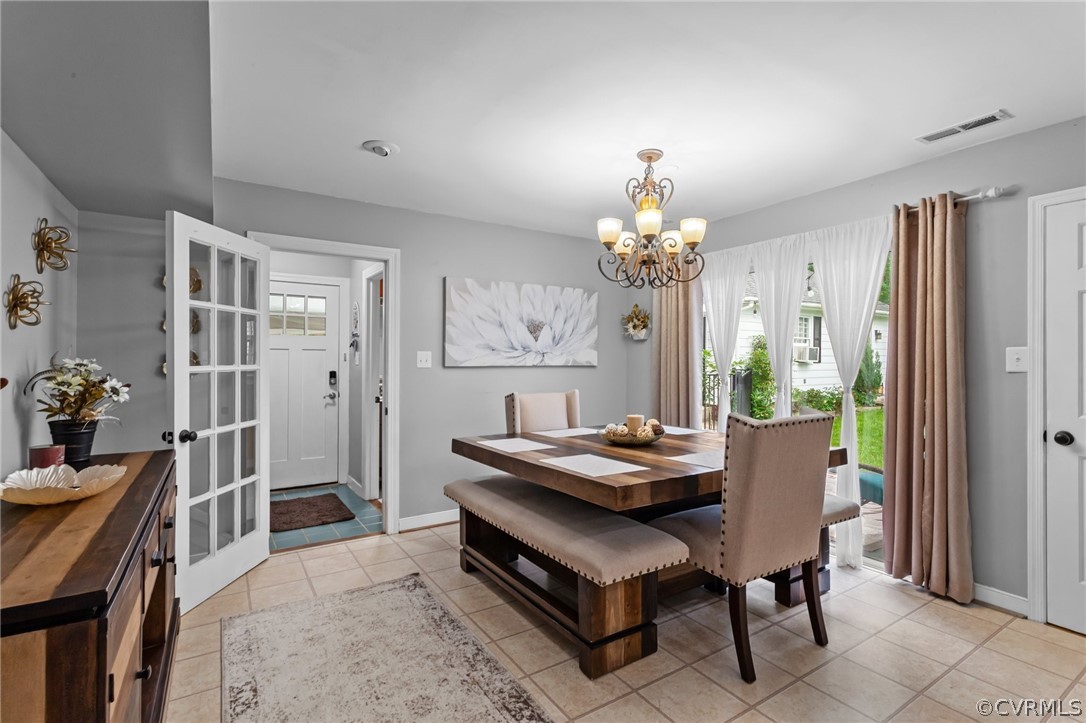 3905 Cresthill Road Chester, VA 23831 - Photo 8 of 49 a dining room with furniture a chandelier and wooden floor