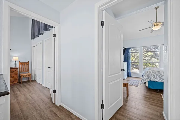 a view of a hallway view with wooden floor and furniture