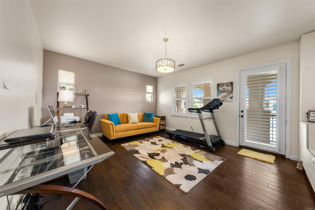 1931 Corte Cantante Chula Vista, CA 91914 - Photo 37 of 61 a living room with furniture a window and gym equipment