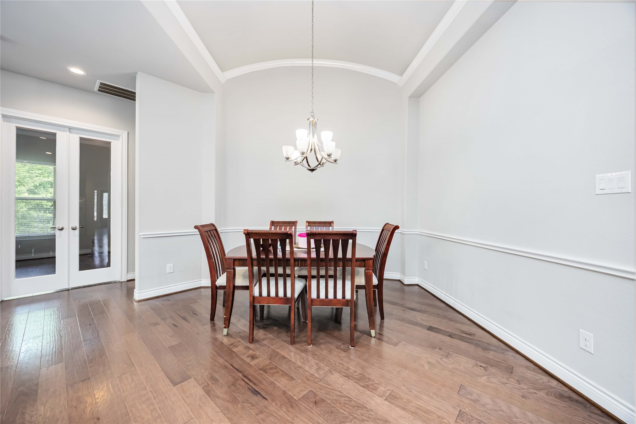 5202 Creekmore Circle Spring, TX 77389 - Photo 14 of 24 a dining room with furniture a chandelier and wooden floor