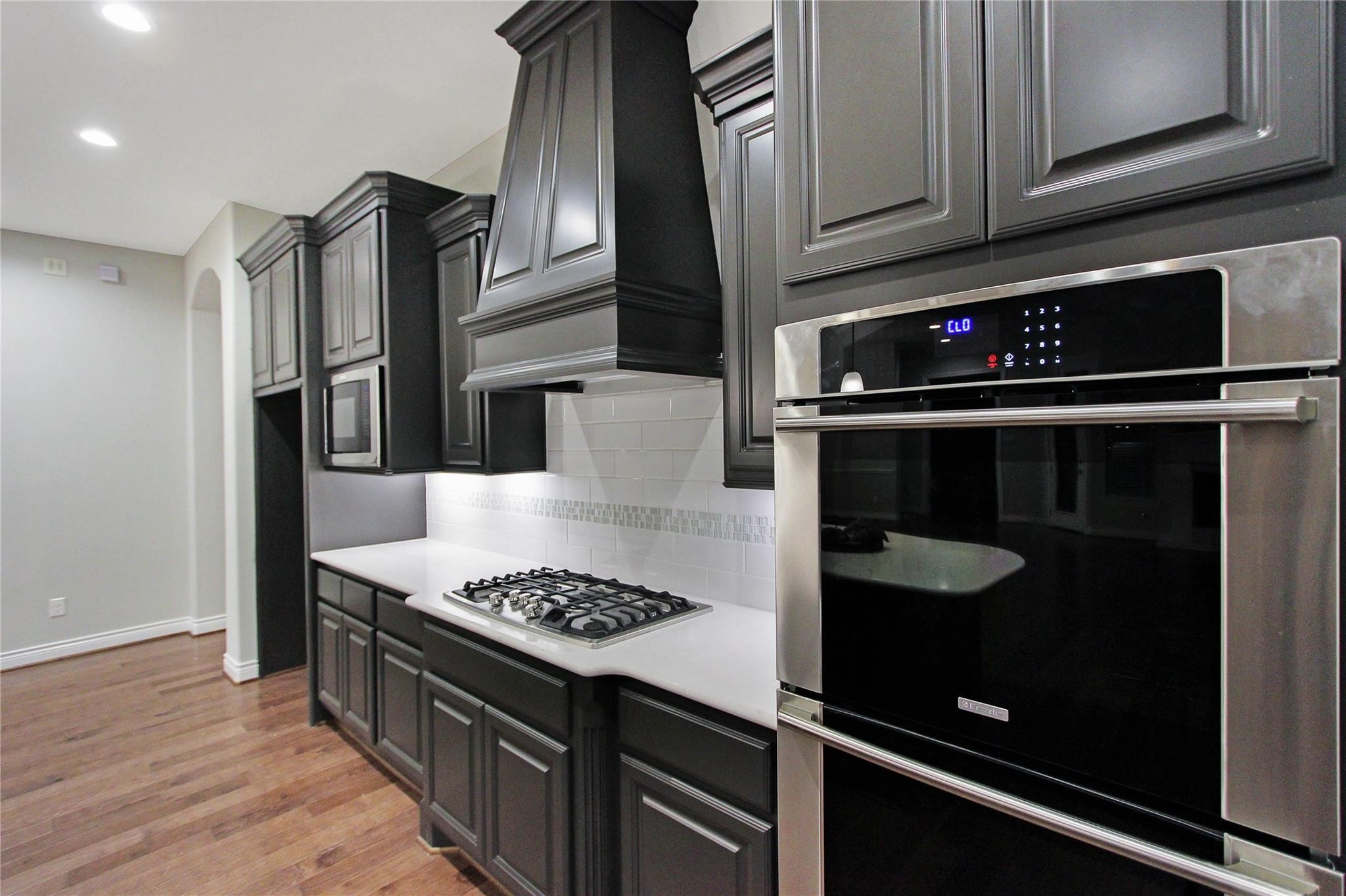 5202 Creekmore Circle Spring, TX 77389 - Photo 6 of 24 a kitchen with stainless steel appliances granite countertop a stove and a refrigerator