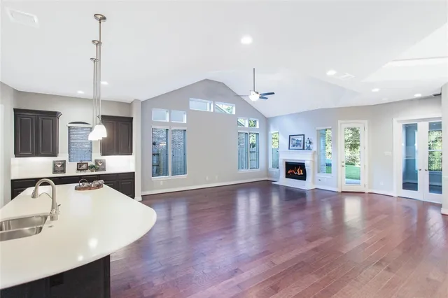 a view of a kitchen area with furniture and wooden floor
