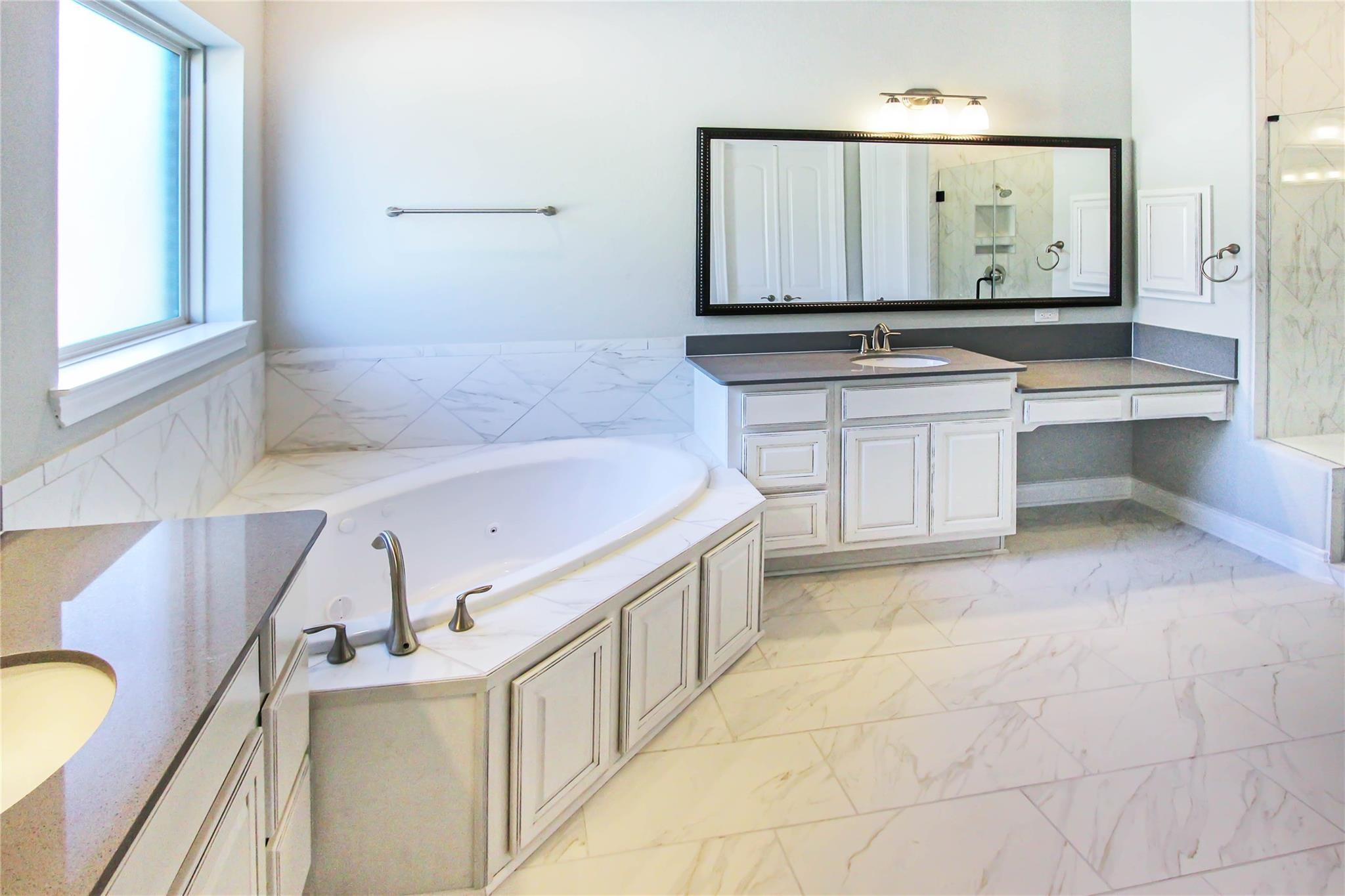 5202 Creekmore Circle Spring, TX 77389 - Photo 10 of 24 a bathroom with a bathtub sink and mirror