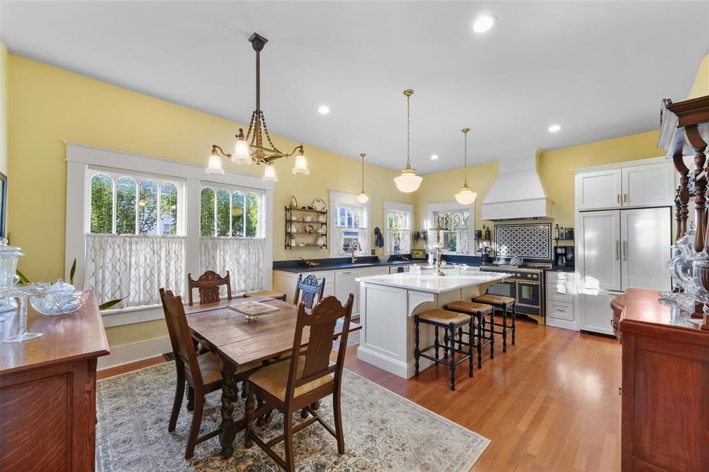 406 Griffith Avenue Terrell, TX 75160 - Photo 18 of 40 This bright kitchen features hardwood floors, white cabinetry, and recessed lighting