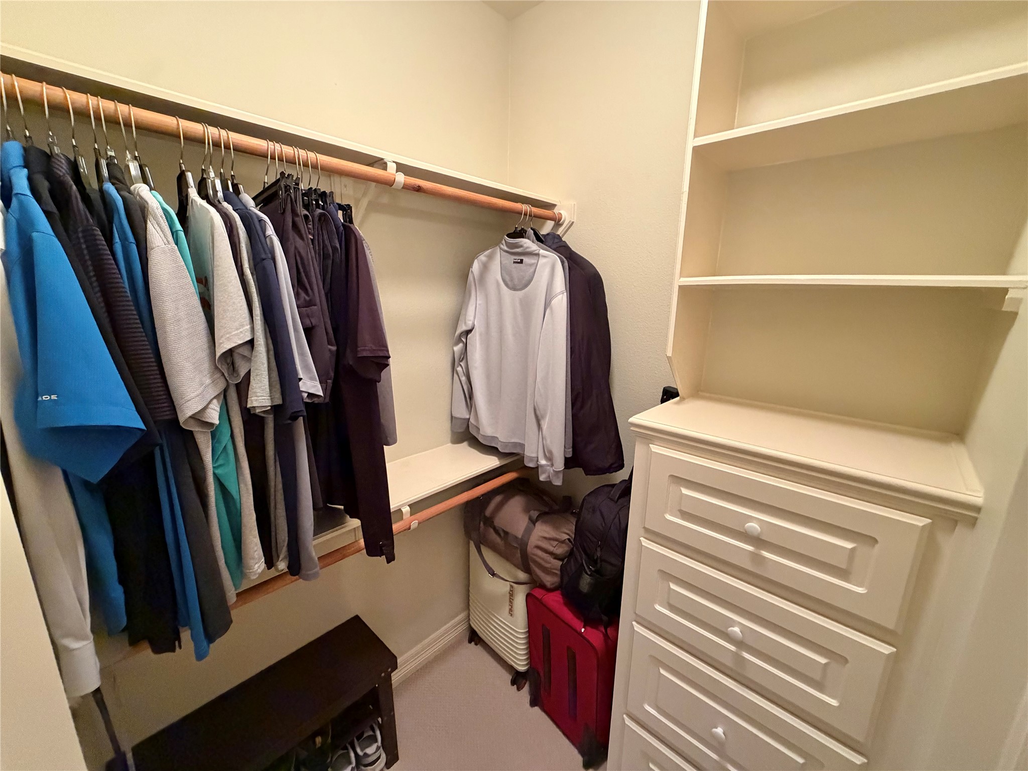 1448 South Blue Bonnet Lane Angleton, TX 77515 - Photo 30 of 43 a view of walk in closet with clothes and shoes