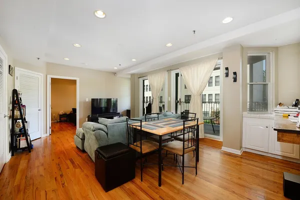 a living room with furniture and a wooden floor