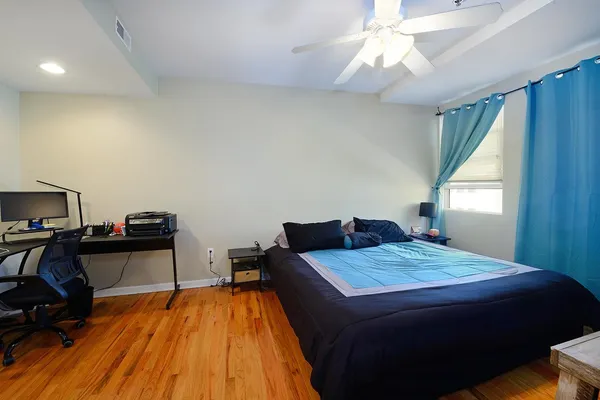 a bedroom with a bed and a chandelier