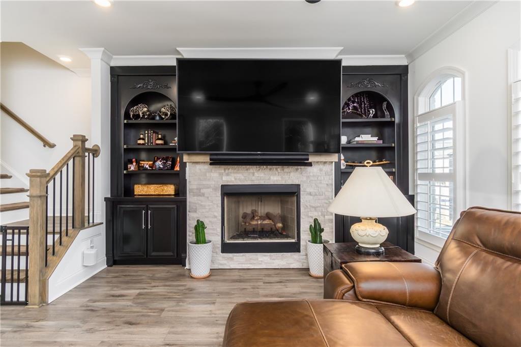 3106 Moor View Road Duluth, GA 30096 - Photo 16 of 39 a living room with furniture a flat screen tv and a fireplace