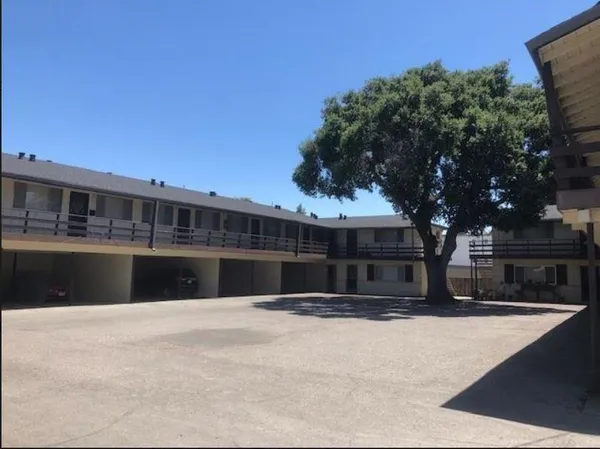 a view of swimming pool with outdoor seating and house in the background