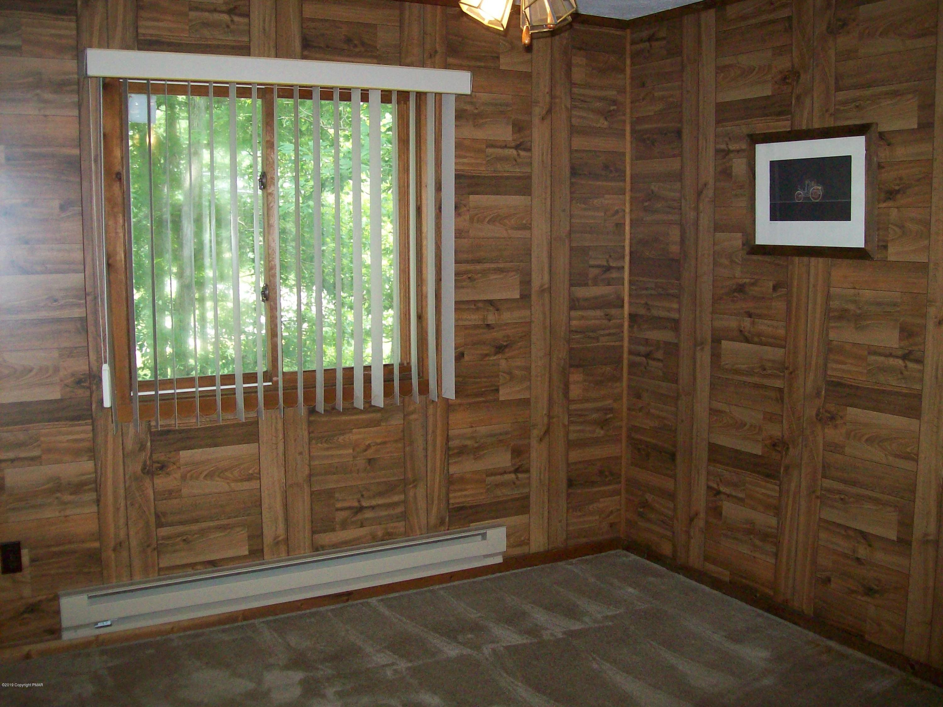 243 Canterbury Road Bushkill, PA 18324 - Photo 17 of 29 a view of an empty room with wooden floor and walls