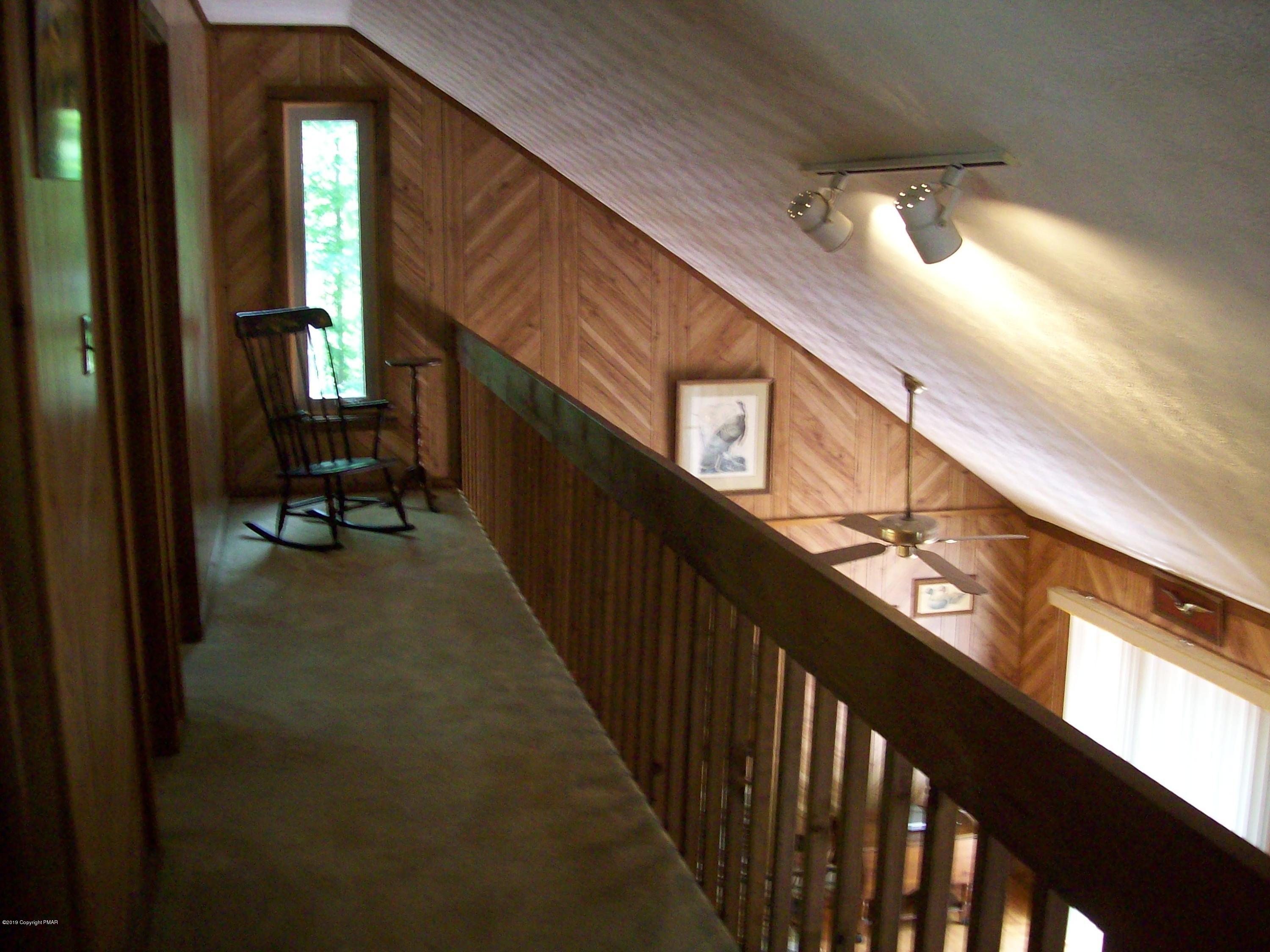 243 Canterbury Road Bushkill, PA 18324 - Photo 18 of 29 a view of a hallway with wooden floor and stairs