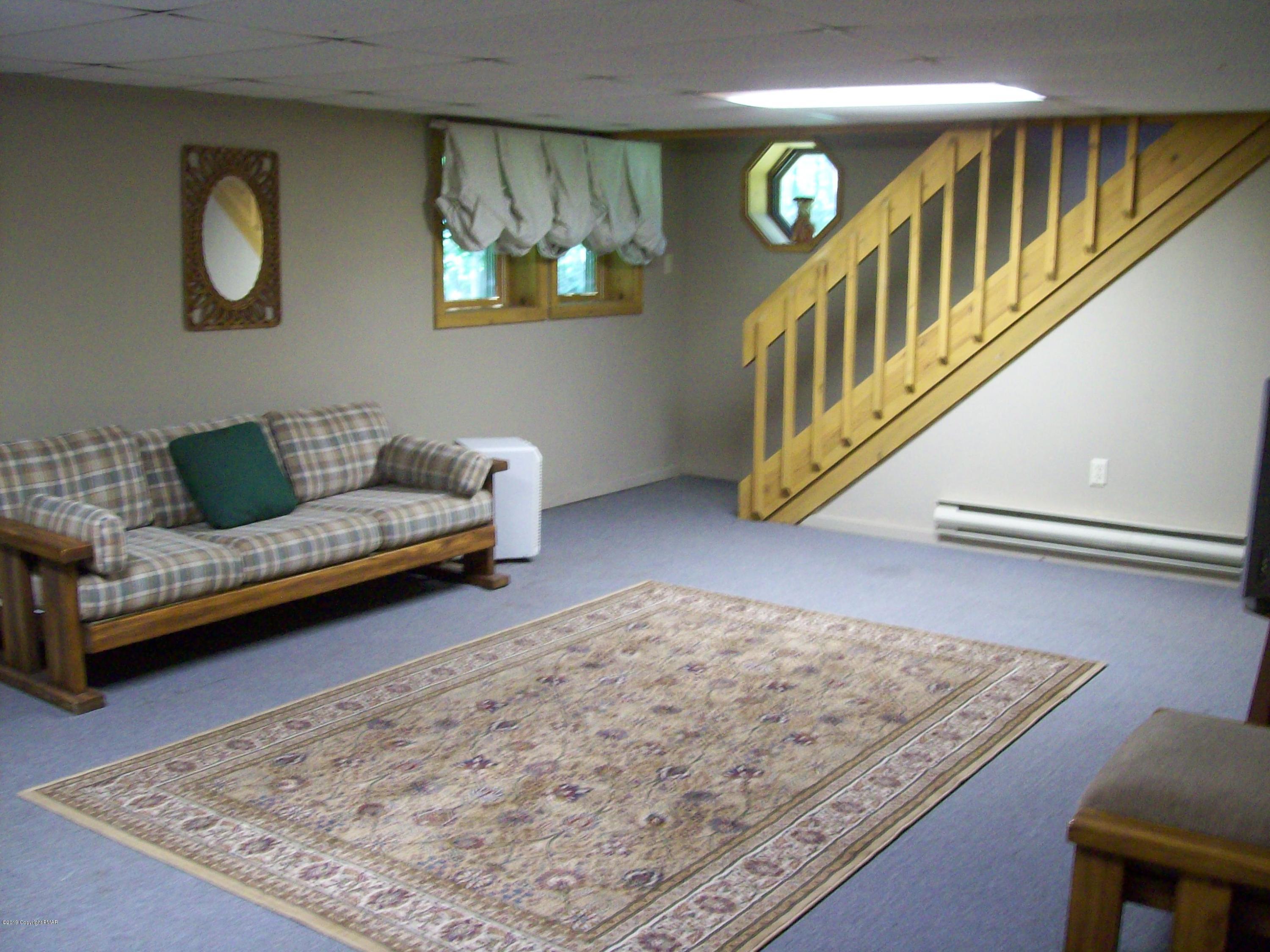 243 Canterbury Road Bushkill, PA 18324 - Photo 20 of 29 a living room with couches and a rug