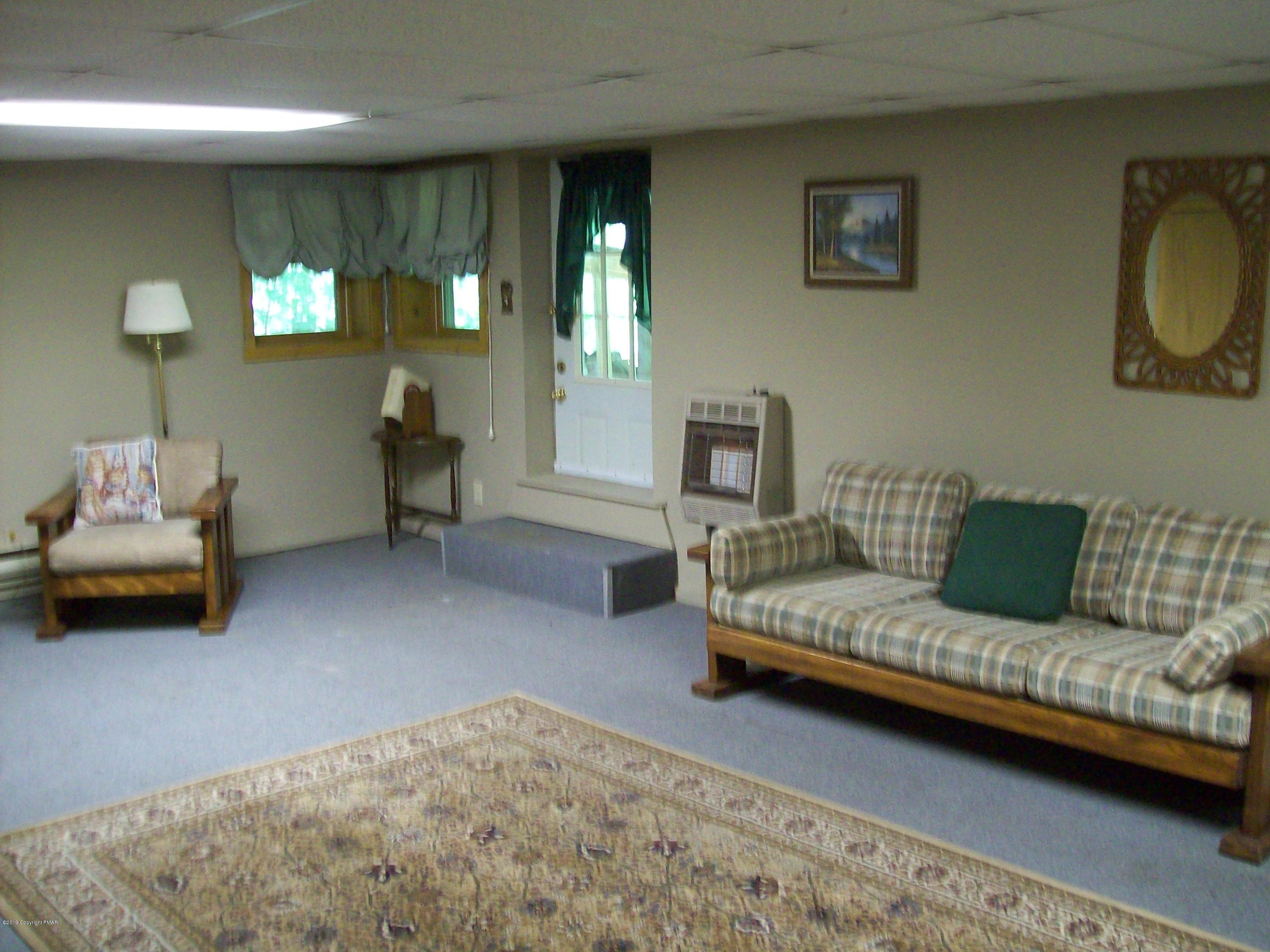 243 Canterbury Road Bushkill, PA 18324 - Photo 24 of 29 a bedroom with furniture and a couch