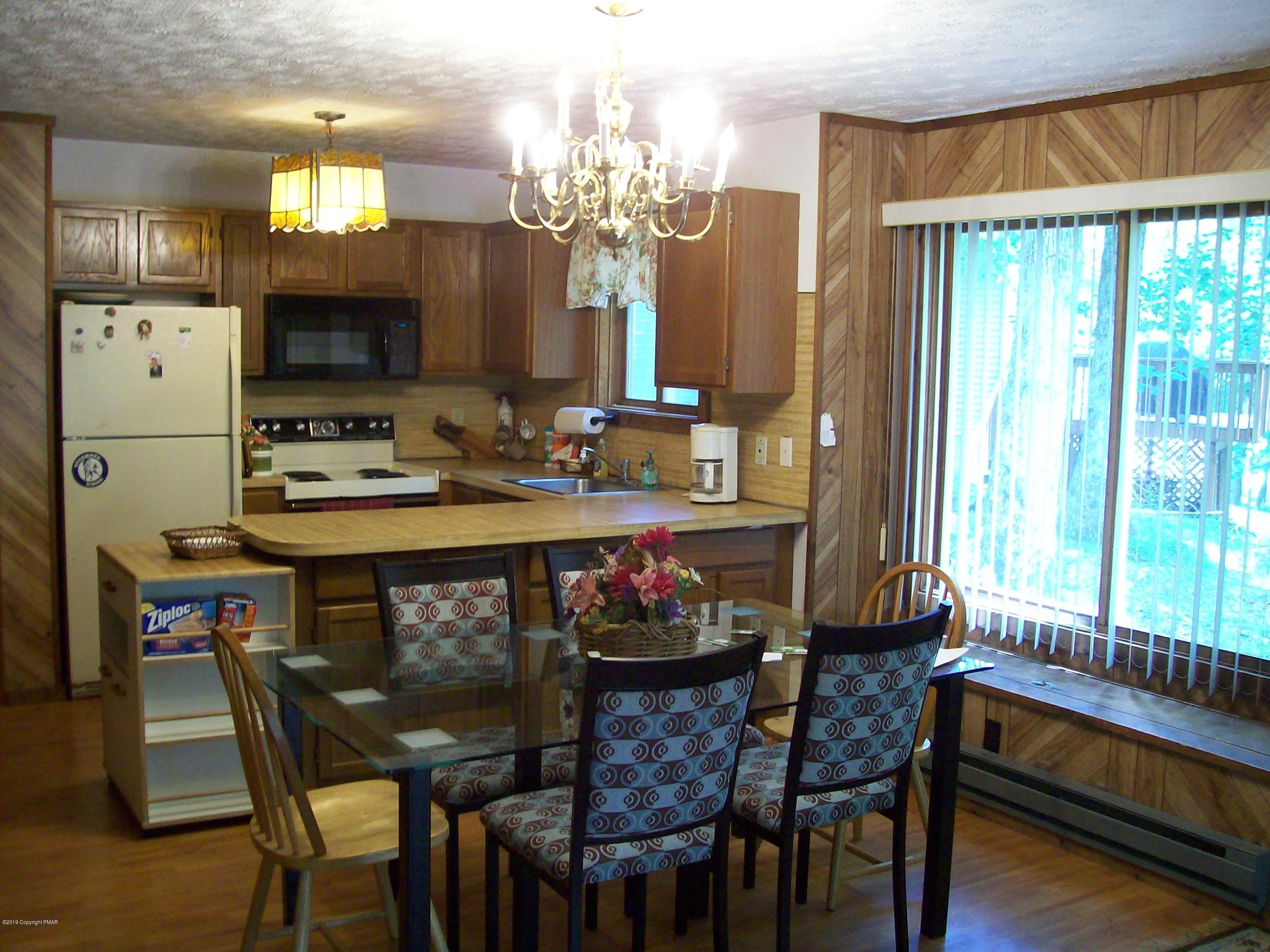 243 Canterbury Road Bushkill, PA 18324 - Photo 6 of 29 a view of a dining room with furniture and chandelier