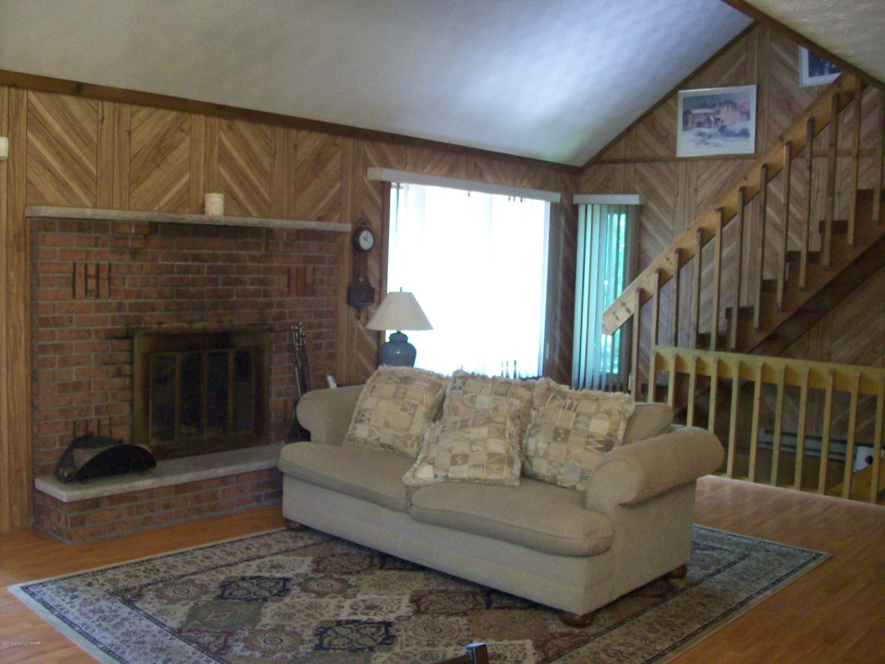 243 Canterbury Road Bushkill, PA 18324 - Photo 7 of 29 a living room with furniture and a fireplace