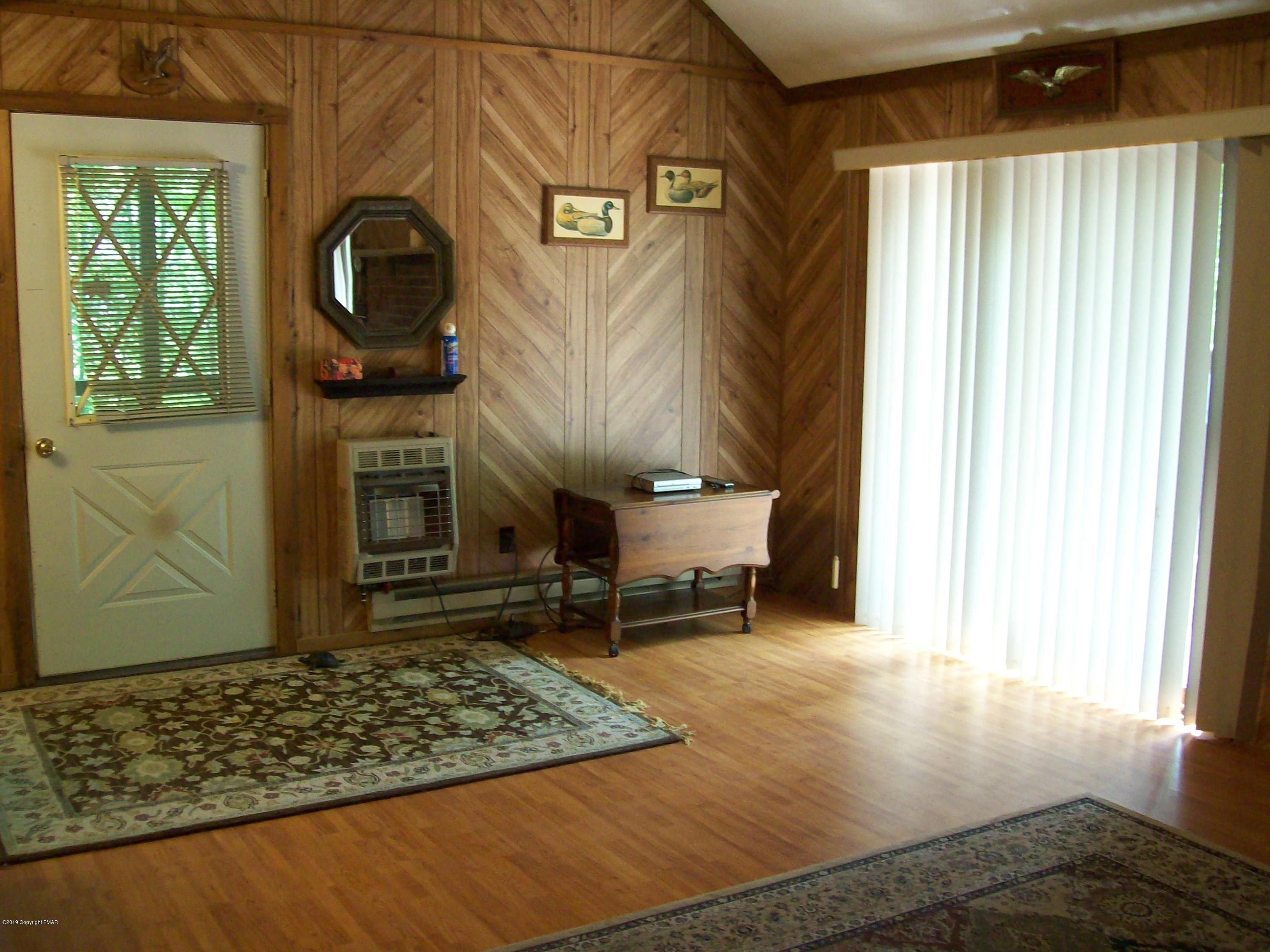 243 Canterbury Road Bushkill, PA 18324 - Photo 8 of 29 a living room with a rug and a window