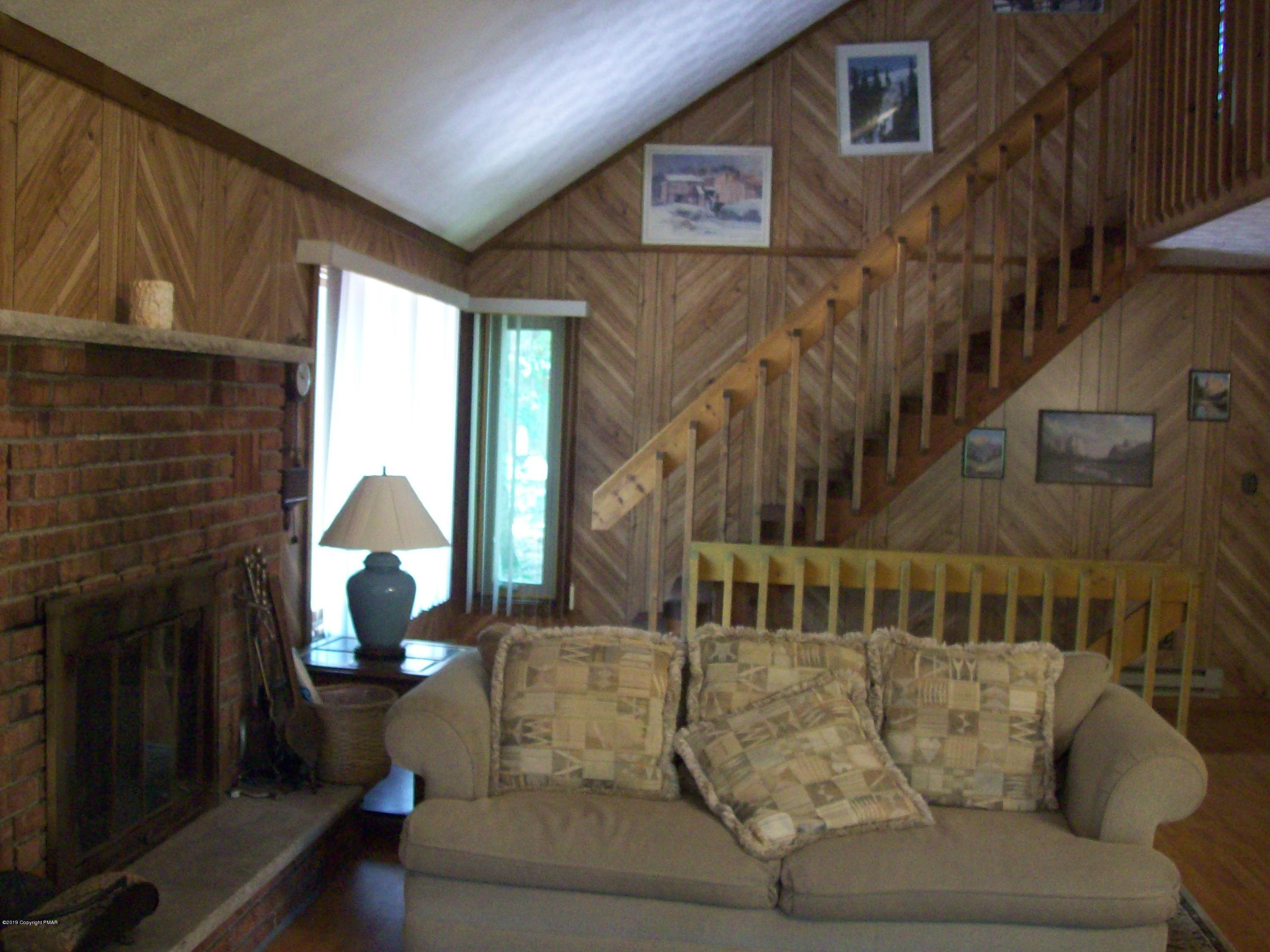 243 Canterbury Road Bushkill, PA 18324 - Photo 9 of 29 a living room with furniture and a fireplace