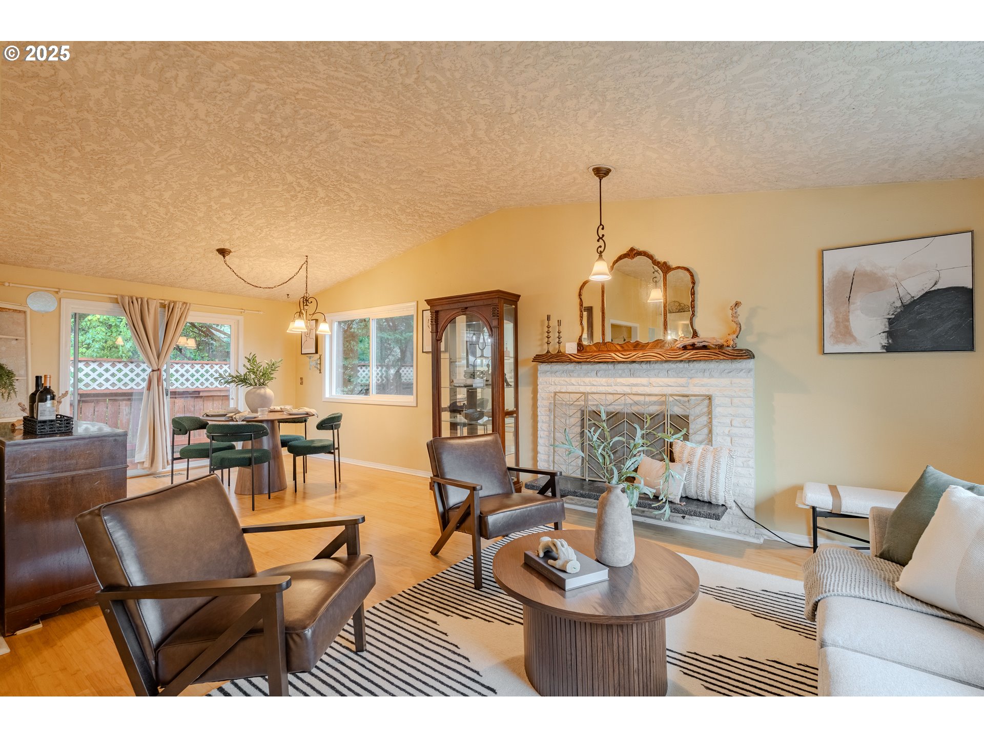 3270 Northwest Ivy Lane Camas, WA 98607 - Photo 3 of 26 a living room with furniture a fireplace and a chandelier