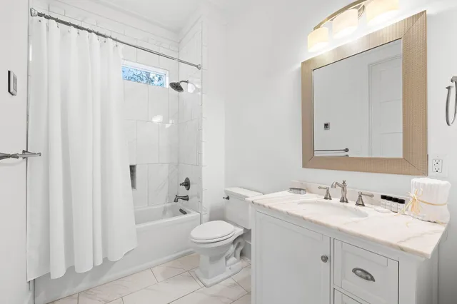 a kitchen with stainless steel appliances granite countertop a dining table chairs refrigerator sink and cabinets