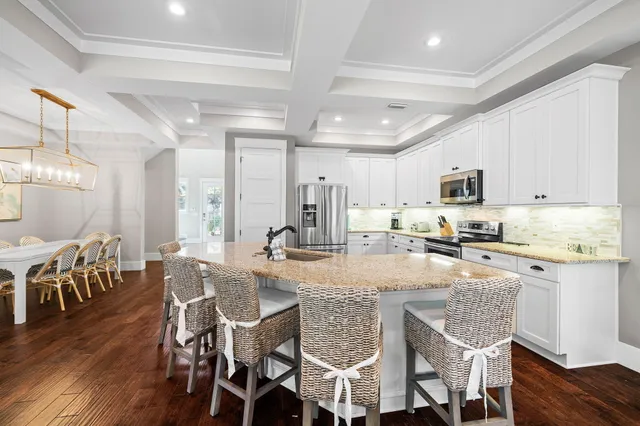 a living room with furniture flat screen tv and a large window