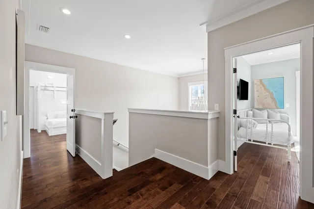 a bedroom with a large bed and a chandelier