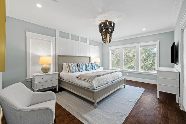 a spacious bedroom with a bed and a flat screen tv