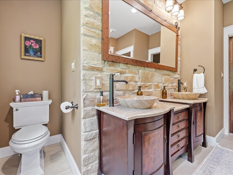 1168 Mt Pleasant Road Bangor, PA 18013 - Photo 55 of 100 Rich wood vanities and natural stone accents define this beautifully finished bathroom space.