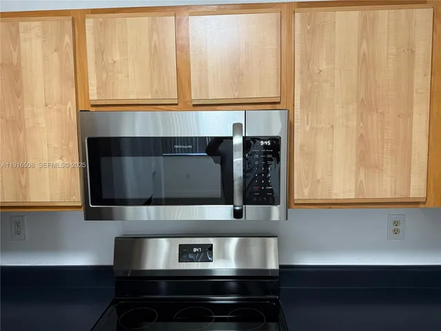 a stove top oven sitting inside of a kitchen
