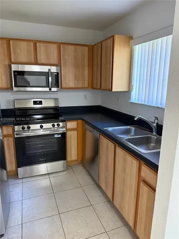 a kitchen with a stove top oven and cabinets
