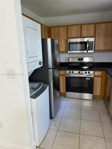a bathroom with a granite countertop sink toilet and mirror