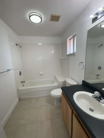 a bathroom with a sink a toilet a mirror and vanity