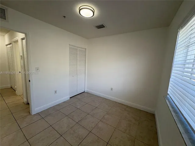 an empty room with a empty space and a window