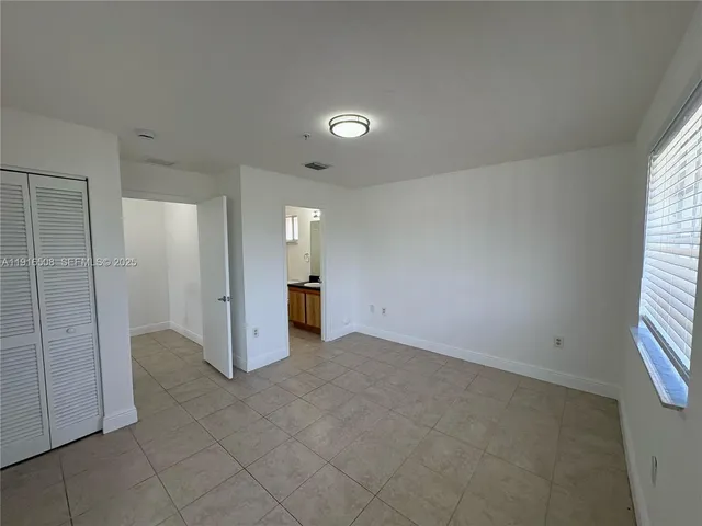 a view of an empty room and a window