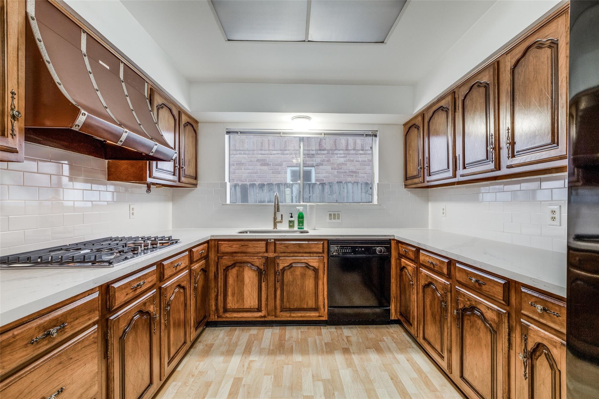 20303 Hampshire Rocks Drive Katy, TX 77450 - Photo 5 of 11 a kitchen with stainless steel appliances granite countertop a sink a stove and cabinets