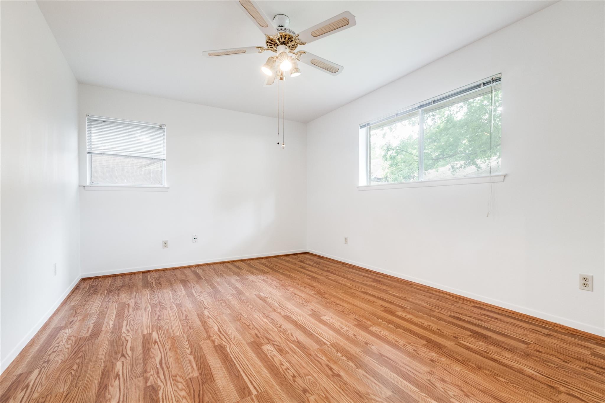 20303 Hampshire Rocks Drive Katy, TX 77450 - Photo 8 of 11 an empty room with wooden floor and windows