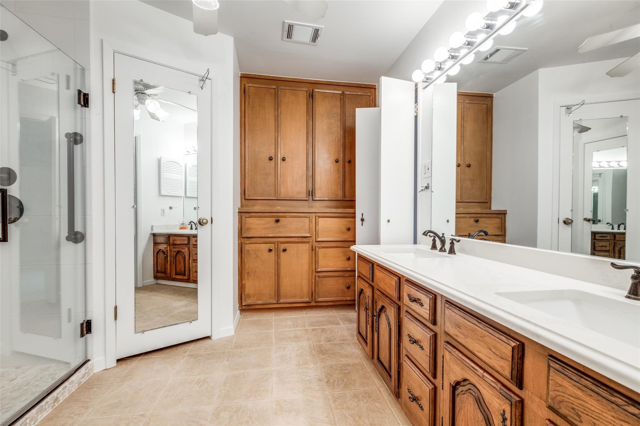 20303 Hampshire Rocks Drive Katy, TX 77450 - Photo 9 of 11 a spacious bathroom with a double vanity sink a mirror and a shower
