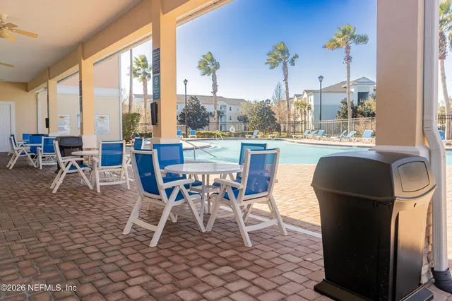 a dining room with furniture a chandelier and wooden floor