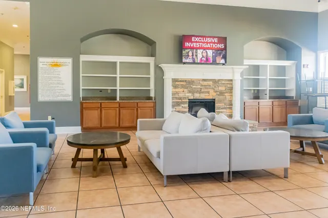 a living room with furniture a table and a fireplace