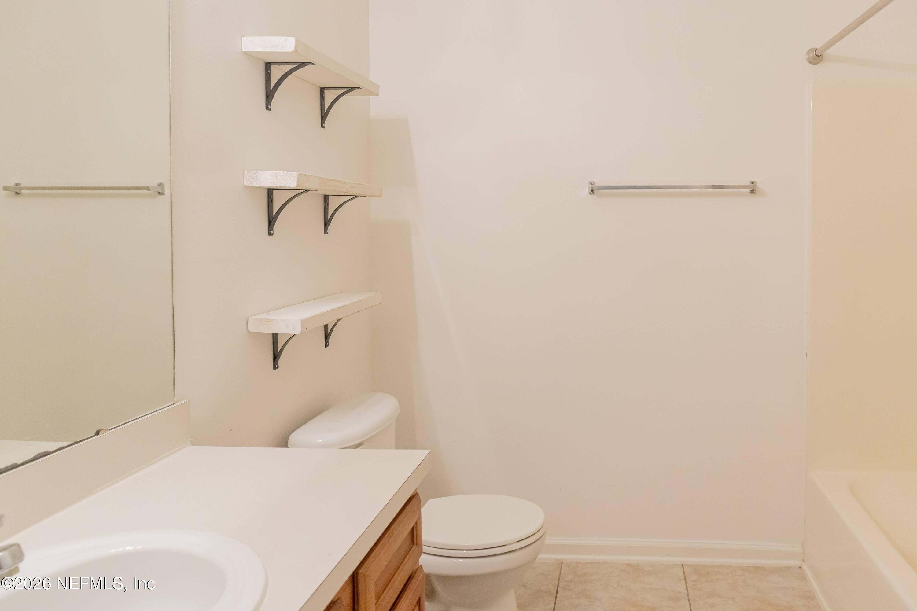 8226 Green Parrot Road, Unit 105 Jacksonville, FL 32256 - Photo 7 of 17 a bathroom with a toilet and a shower