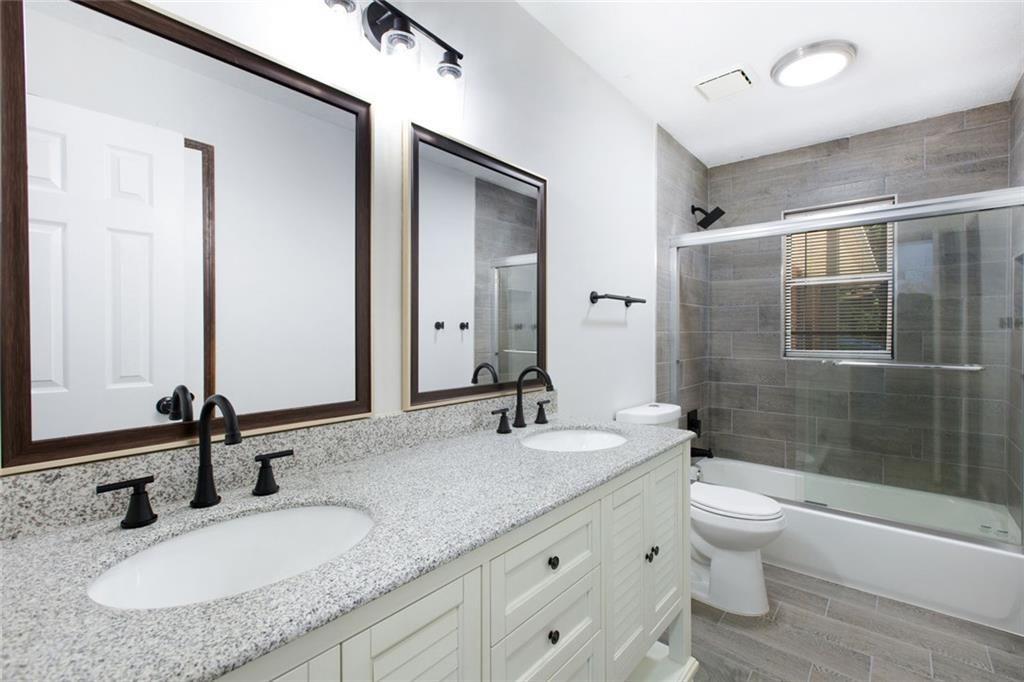 6464 Westerly Way Douglasville, GA 30135 - Photo 20 of 40 a bathroom with a granite countertop sink toilet and shower