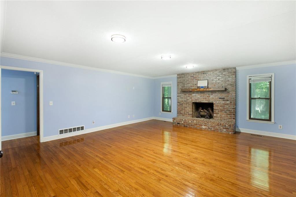 6464 Westerly Way Douglasville, GA 30135 - Photo 2 of 40 a view of empty room with wooden floor and fireplace