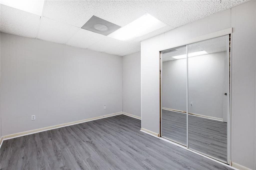 6464 Westerly Way Douglasville, GA 30135 - Photo 25 of 40 an empty room with wooden floor and mirror