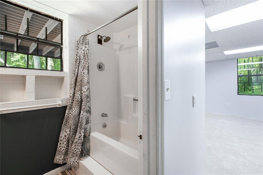 6464 Westerly Way Douglasville, GA 30135 - Photo 26 of 40 a bathroom with a bathtub a shower and a window