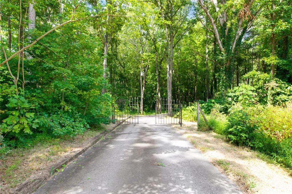 6464 Westerly Way Douglasville, GA 30135 - Photo 36 of 40 a view of a road with plants and large trees
