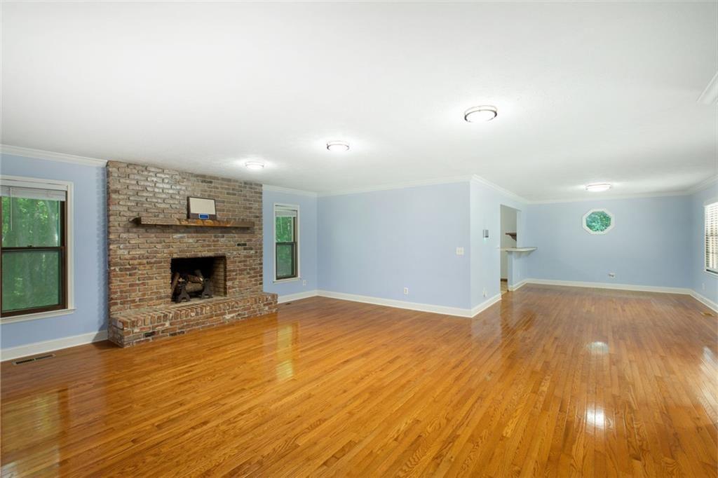 6464 Westerly Way Douglasville, GA 30135 - Photo 4 of 40 a view of empty room with wooden floor and fireplace