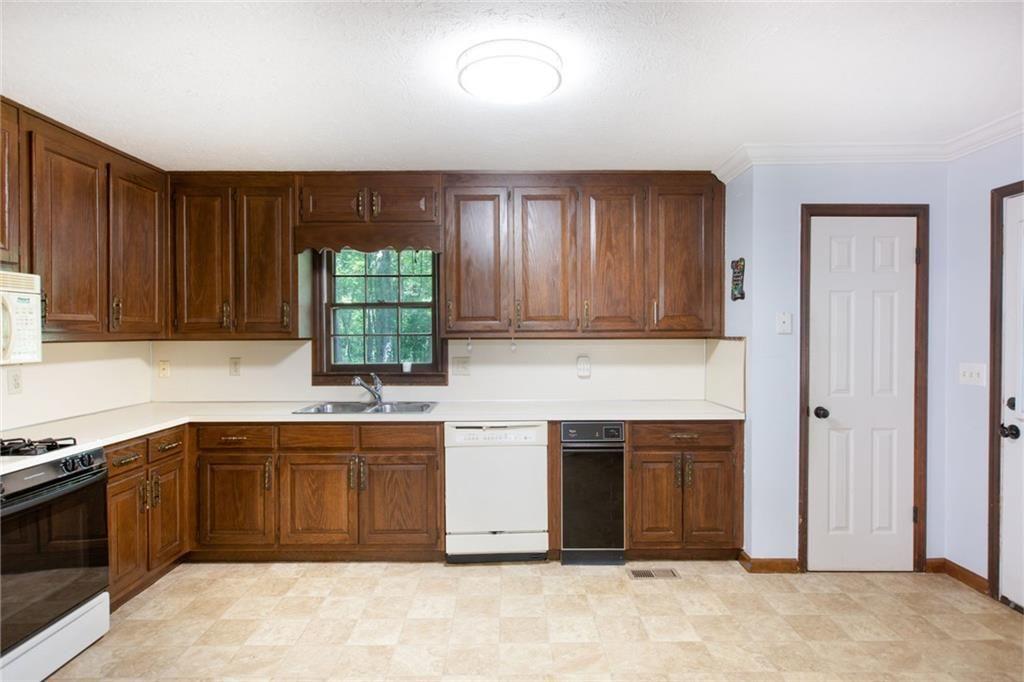 6464 Westerly Way Douglasville, GA 30135 - Photo 7 of 40 a kitchen with stainless steel appliances granite countertop a stove sink and cabinets