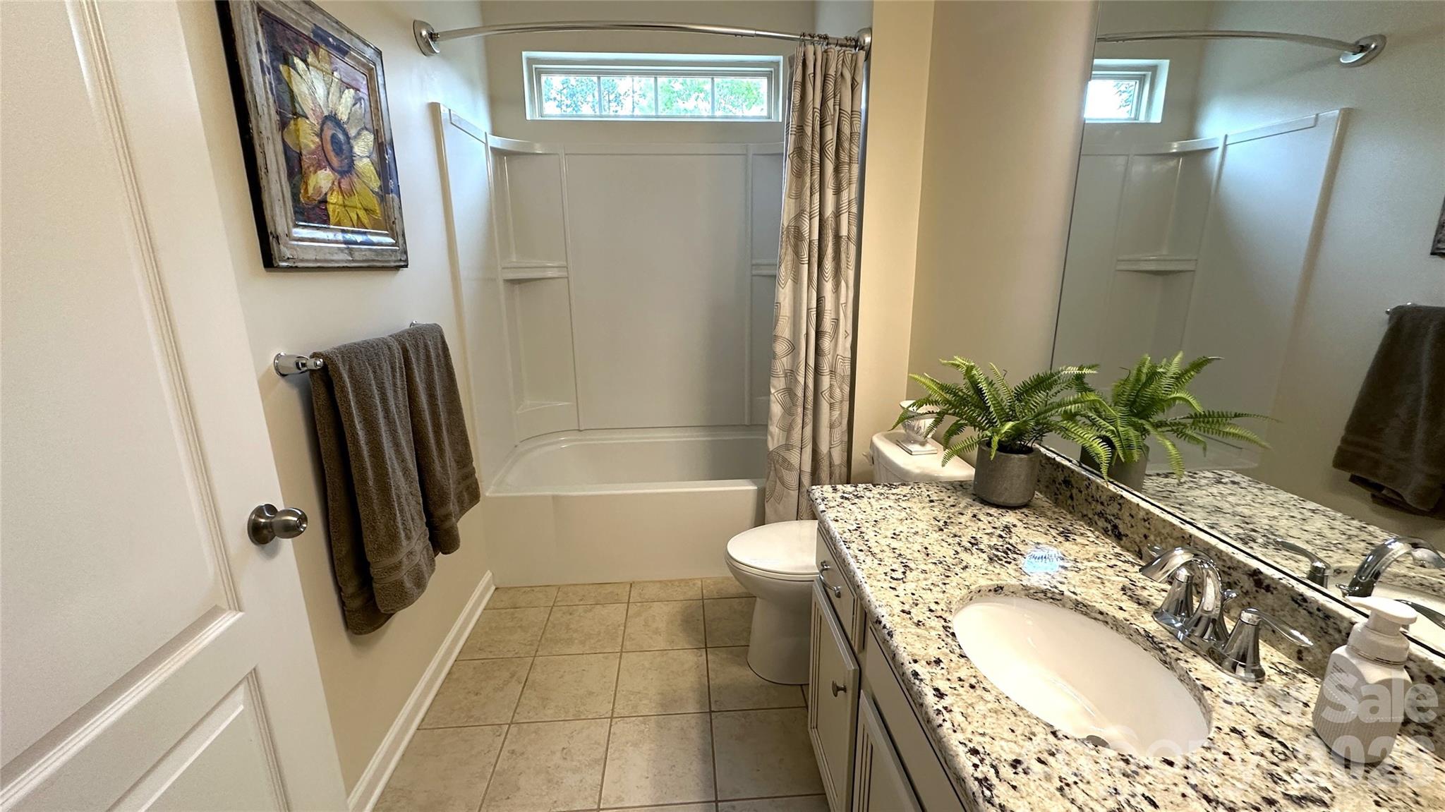 596 Moses Drive Fort Mill, SC 29707 - Photo 18 of 29 a bathroom with a tub sink and mirror